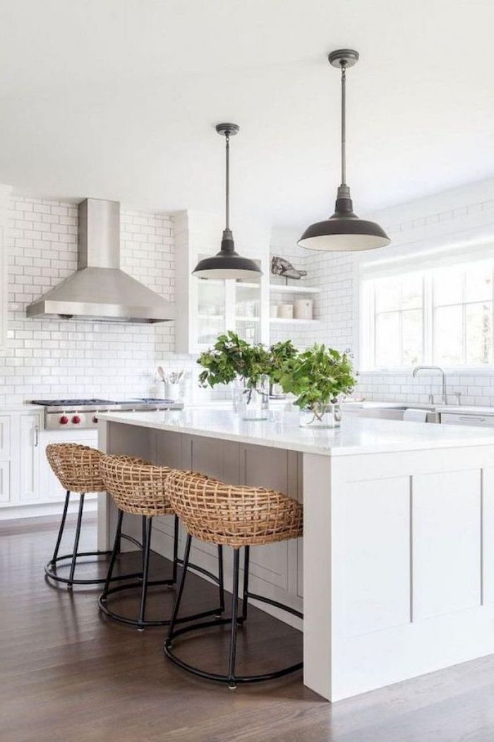 rustic farmhouse kitchen white kitchen island black bar stools on wooden floor white subway tiles backsplash