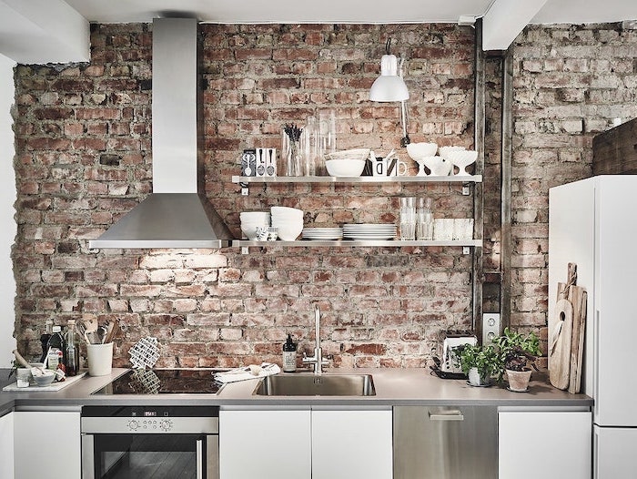 subway tile backsplash brick wall white cabinets gray countertop open shelving with wooden shelves