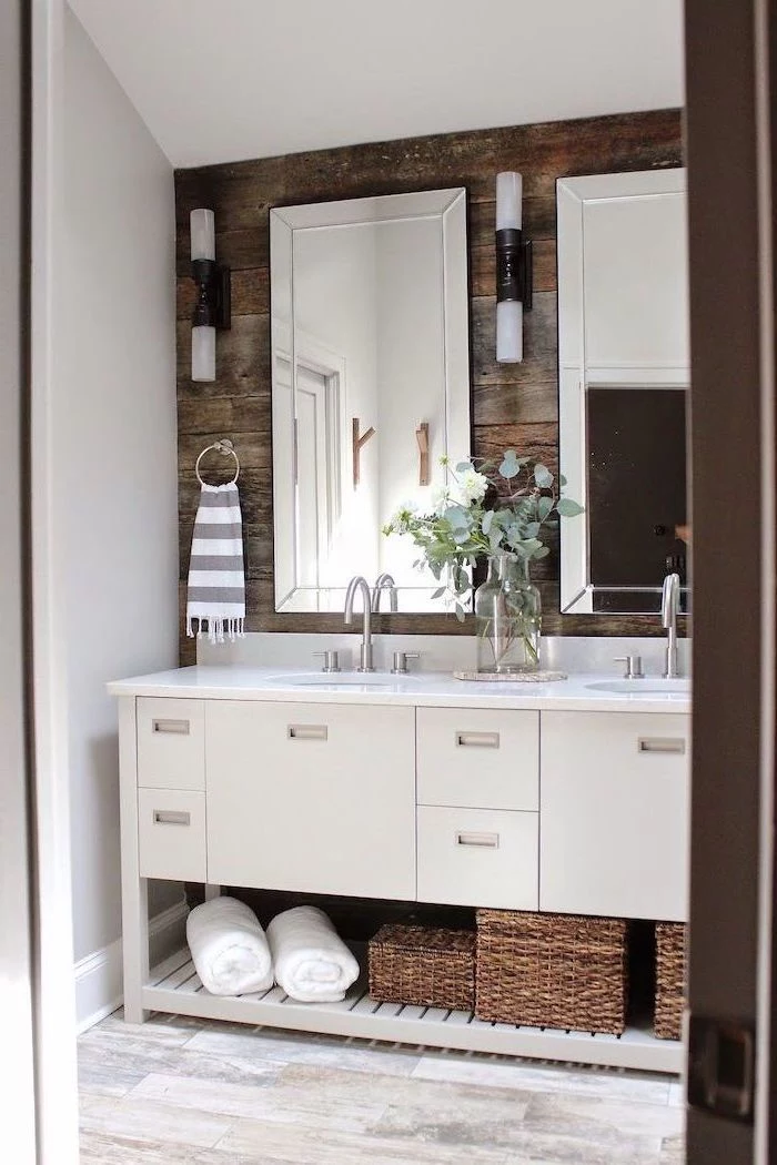 two mirrors on wooden wall above white cabinet with two sinks small bathroom remodel ideas wooden floor