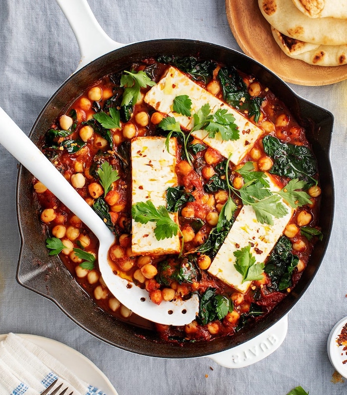 vegan chickpea recipes baked feta cheese in tomato sauce with chickpeas and spinach garnished with parsley