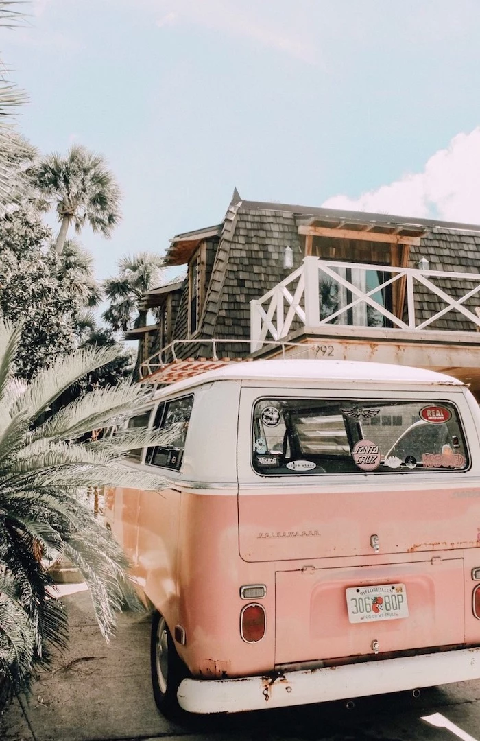 vsco girl backgrounds pink caravan parked in front of house with lots of palm trees in the front yard blue sky above it