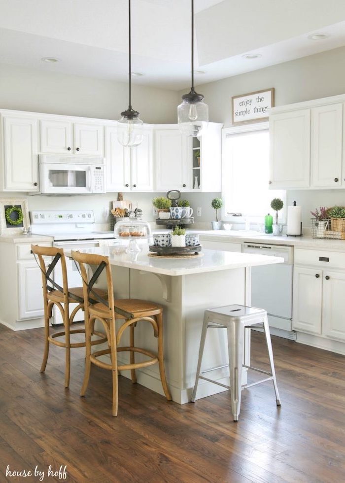 white cabinets white countertops modern farmhouse decor ideas wooden bar stools next to white kitchen island dark wooden floor