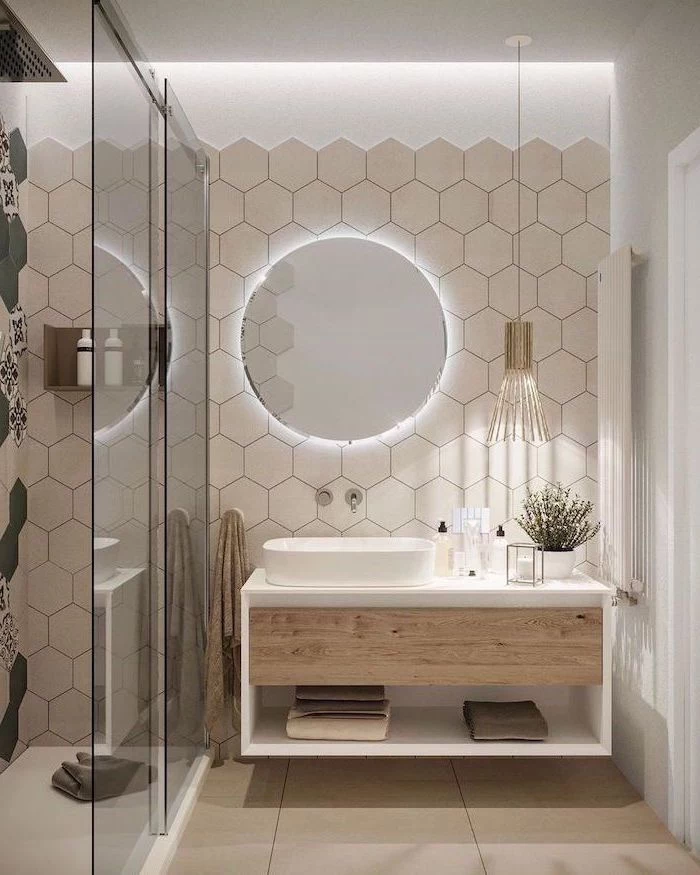 white honeycomb tiles floating wooden cabinet round mirror with led light glass shower cabin small bathroom remodel