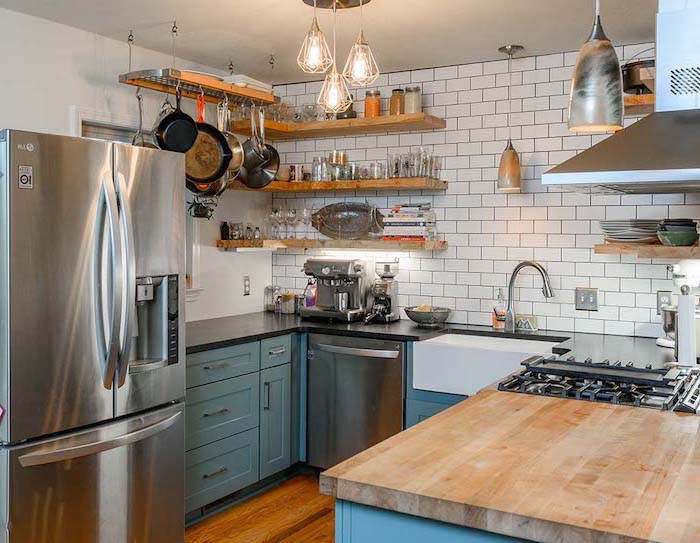 white subway tiles backsplash white farmhouse kitchen blue cabinets black countertops open shelving wooden floor