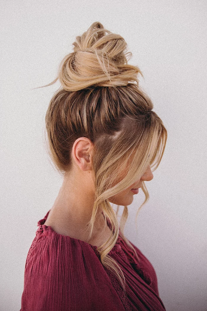 woman wearing dark burgundy blouse cute easy hairstyles for school dark blonde hair with highlights hair in a bun two strands of hair in front