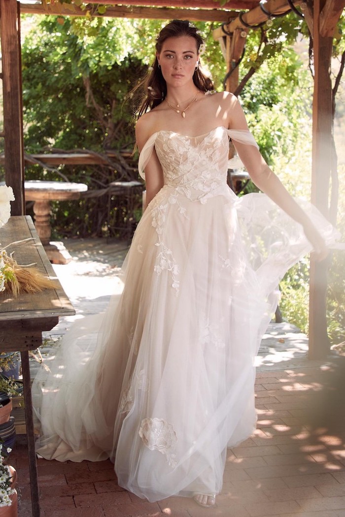 woman with brunette long hair off the shoulder mermaid wedding dress wearing dress made of tulle and lace