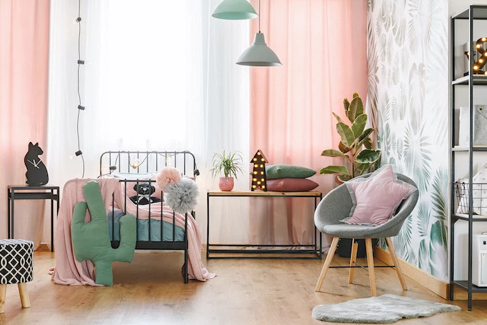 accent wall with palm leaves pink curtains teenage girl beds single bed with black metal frame wooden floor