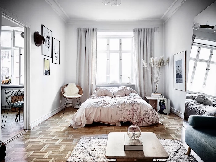 bedroom decor in white with wooden floor pampas grass decor glass vase with pampass grass on the night stand