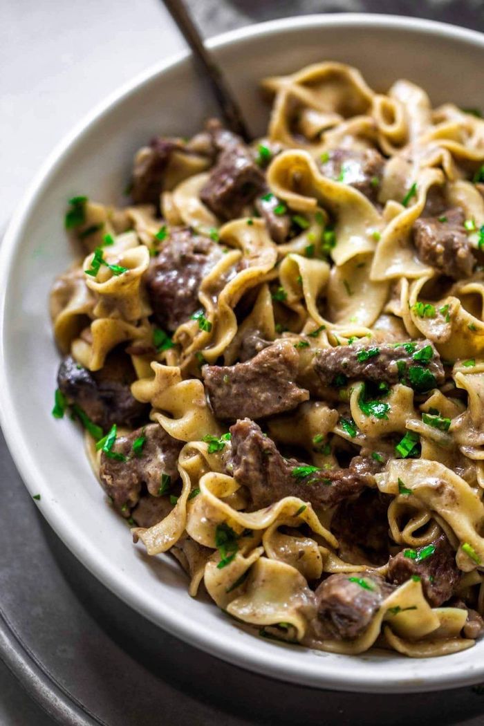 beef stroganoff cooked in instant pot best instapot recipes garnished with chopped parsley placed in white plate