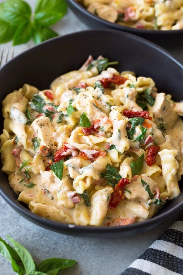 best pressure cooker recipes chicken pasta with sun dried tomatoes cooked in instant pot garnished with basil leaves