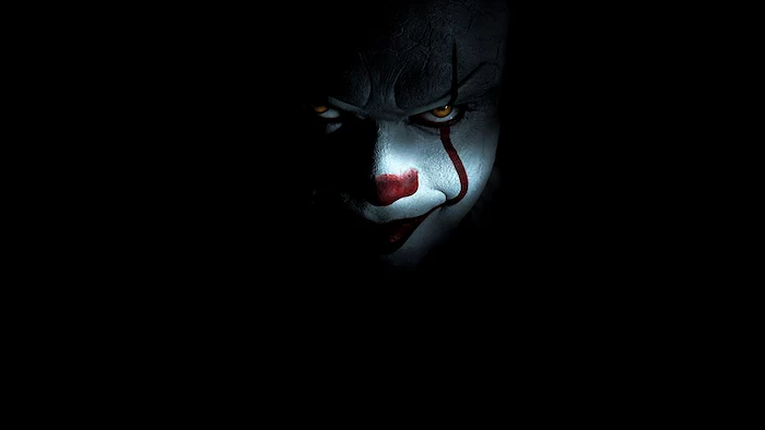 bill skarsgard dressed as it from the movie it looking at the camera halloween wallpaper black background