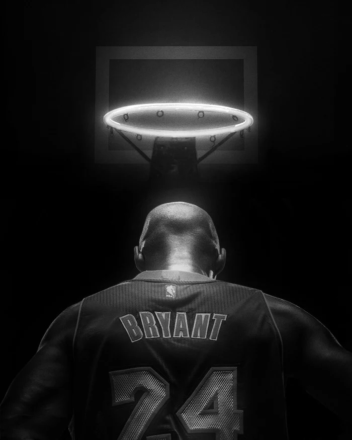 black and white photo kobe bryant and gigi wallpaper kobe photographed from the back wearing number twenty four on lakers jersey baskeyball hoop above him as halo
