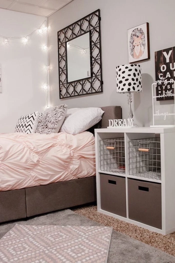 black framed mirror above bed with gray white black throw pillows cute room ideas for a teenage girl night stand next to it