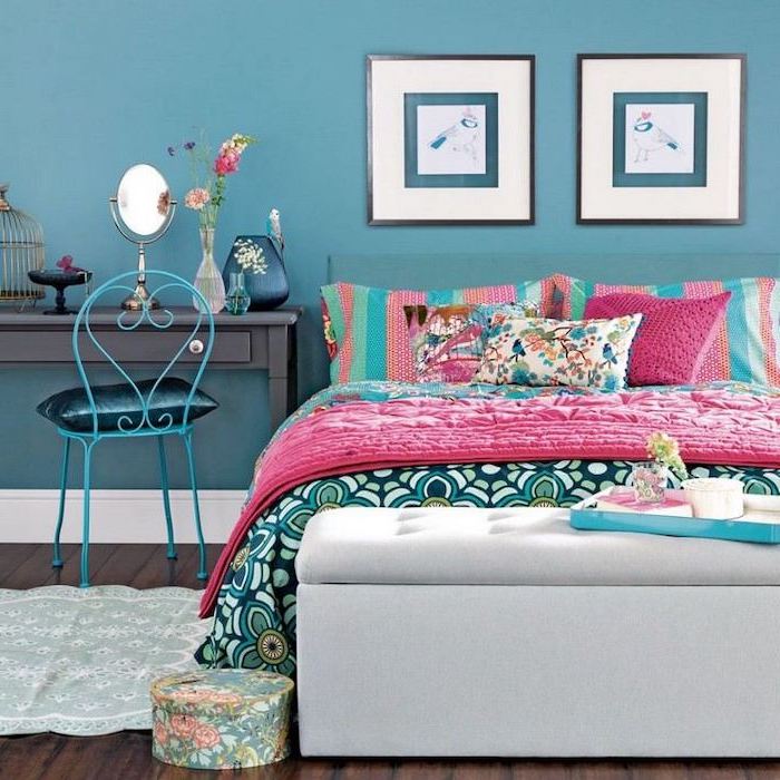 blue wall teenage girl beds double bed with colorful throw pillows and blankets dark wooden floor black desk