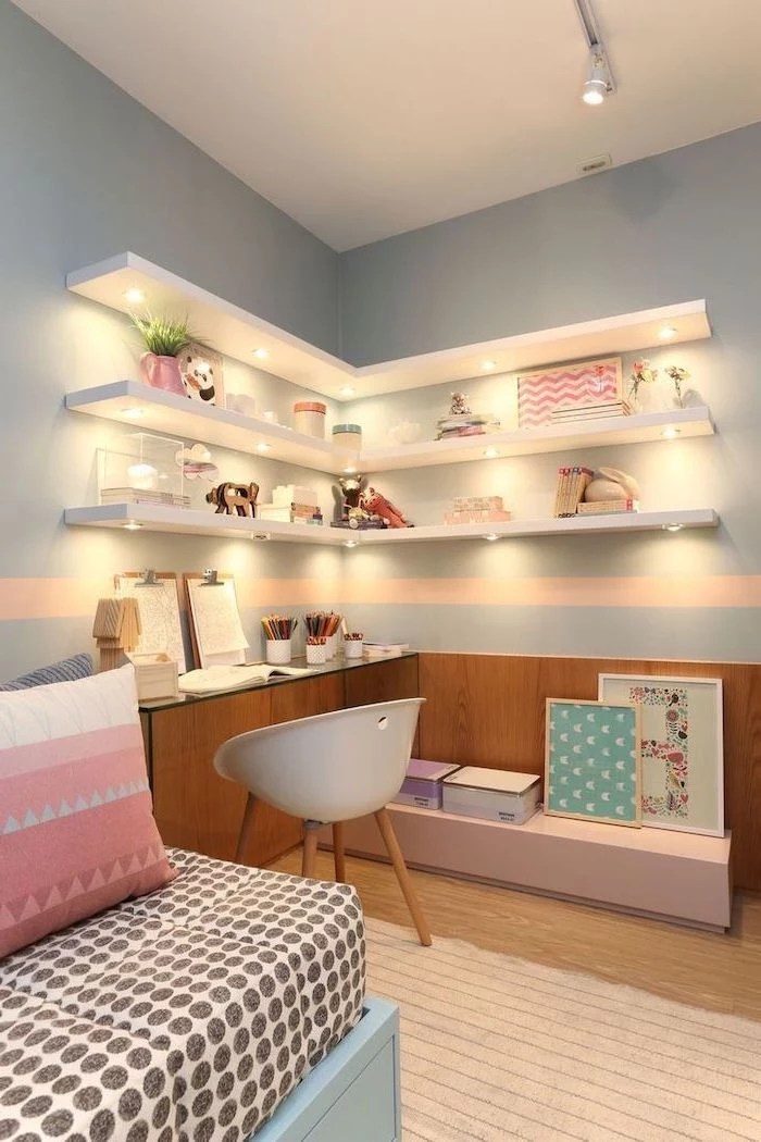 bookshelves with led lights on light blue wall above desk teenage girl bedroom ideas wooden floor pink throw pillows on the bed