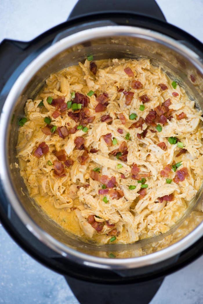 chicken cooked with creamy sauce inside instant pot best instant pot recipes garnished with bacon and chives