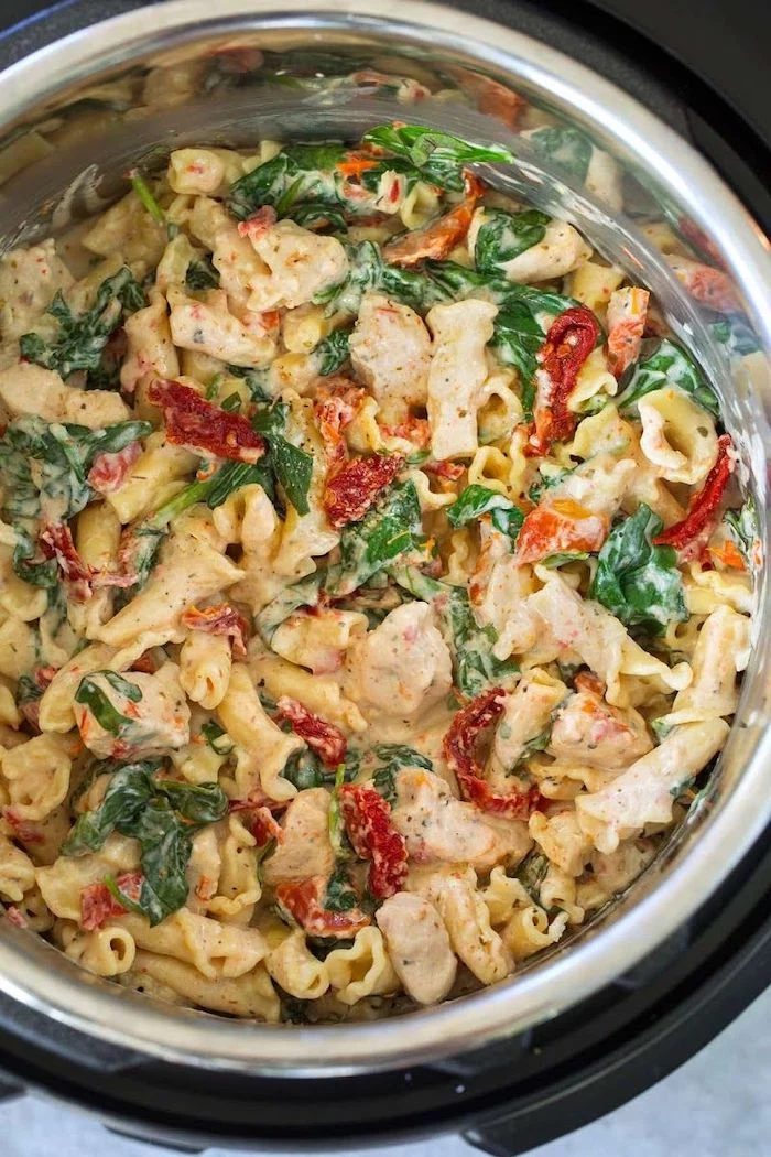 chicken pasta cooked in instant pot best pressure cooker recipes with sun dried tomatoes and basil leaves