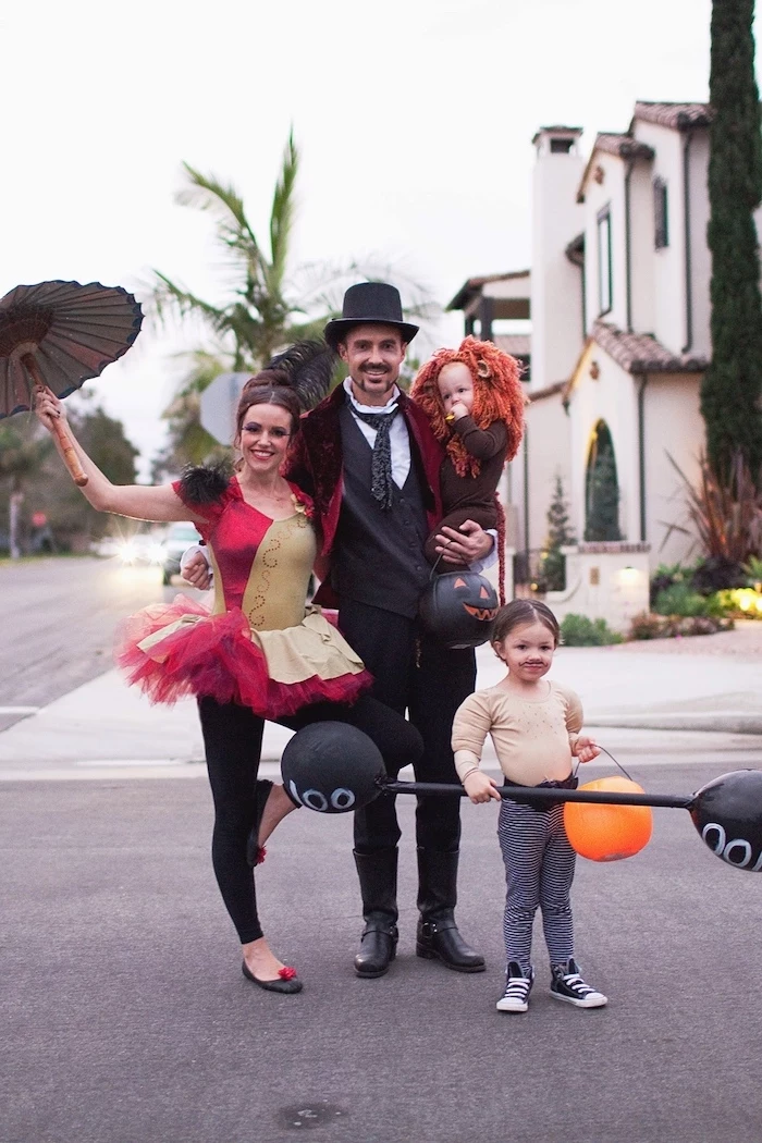 circus artists family of 3 halloween costumes dad as magician mom as acrobatic performer photographed on the street