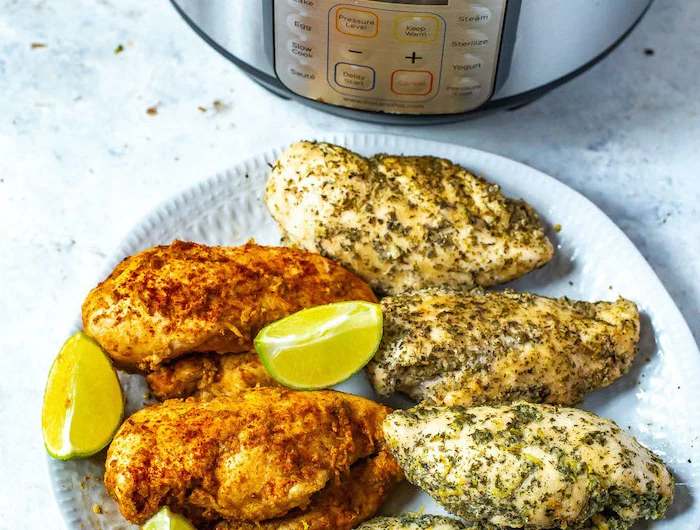 cooked chicken breasts with lime wedges on white plate best instant pot recipes placed in front of instant pot