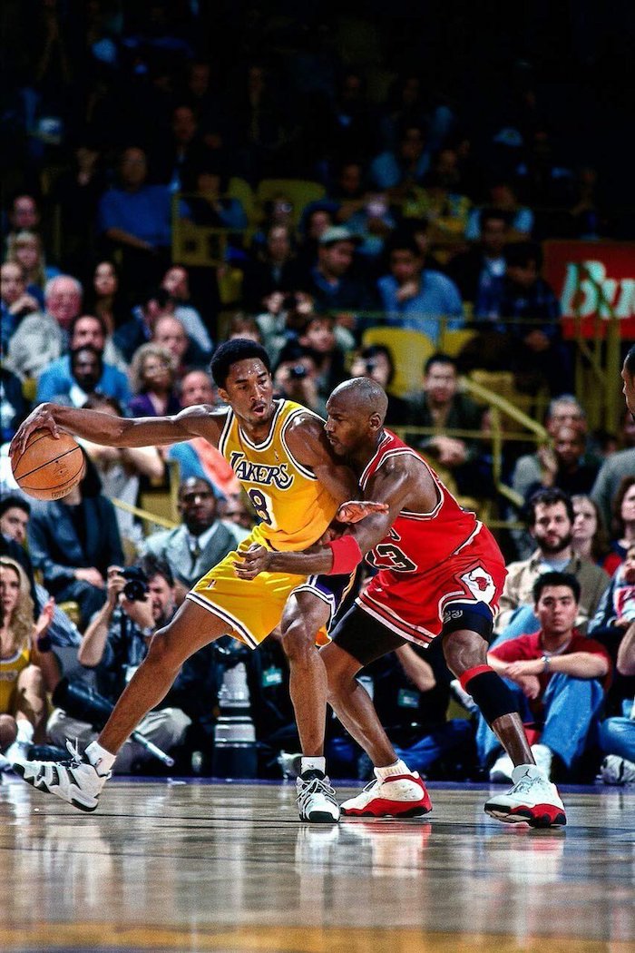 cool kobe bryant wallpapers michael jordan in bulls uniform guarding kobe bryant in lakers uniform on the court crowd in the background