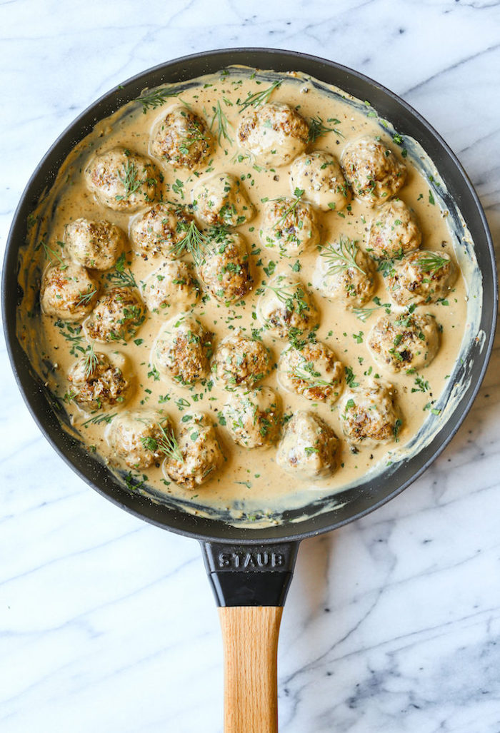 creamy swedish meatballs instant pot chicken recipes healthy inside a pan garnished with chopped parsley and dill