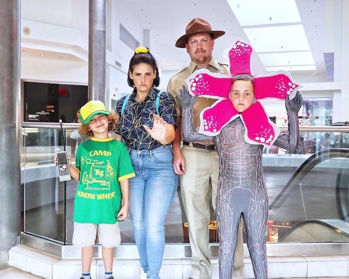 dad dressed as hhopper mom as eleven kid as dustin kid as the demogorgon family halloween costumes with baby stranger things inspired costumes