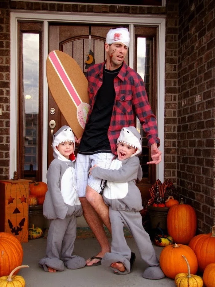 dad dressed as surfer attacked by sharks family halloween costumes with baby two kids dressed as sharks