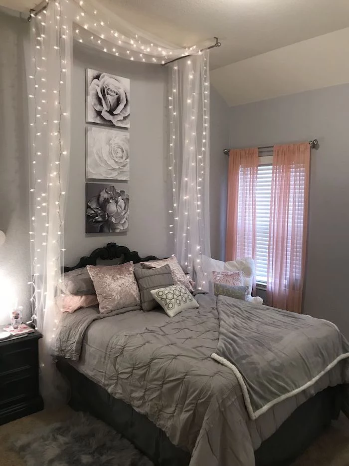 fairy lights in tulle above the bed teen girl room ideas pink and gray throw pillows on the bed gray walls with floral art