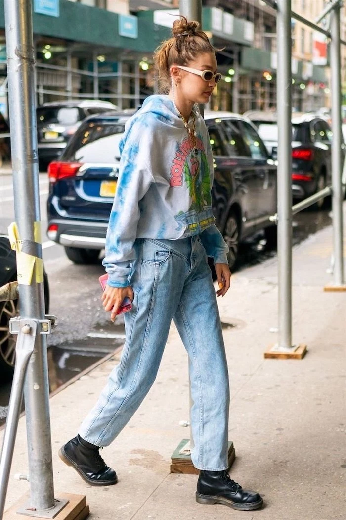 fall outfits for women gigi hadid walking on the sidewalk wearing baggy washed jeans tie dye sweatshirt black leather combat boots