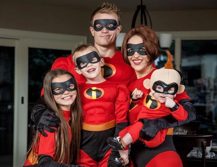family of five dressed as the characters from the incredibles family halloween costumes with baby photographed together smiling