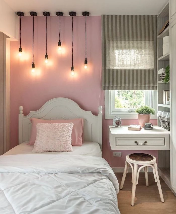 floating desk next to the bed teenage girl bedroom ideas for small rooms pink wall with hanging lamps with different length above the bed