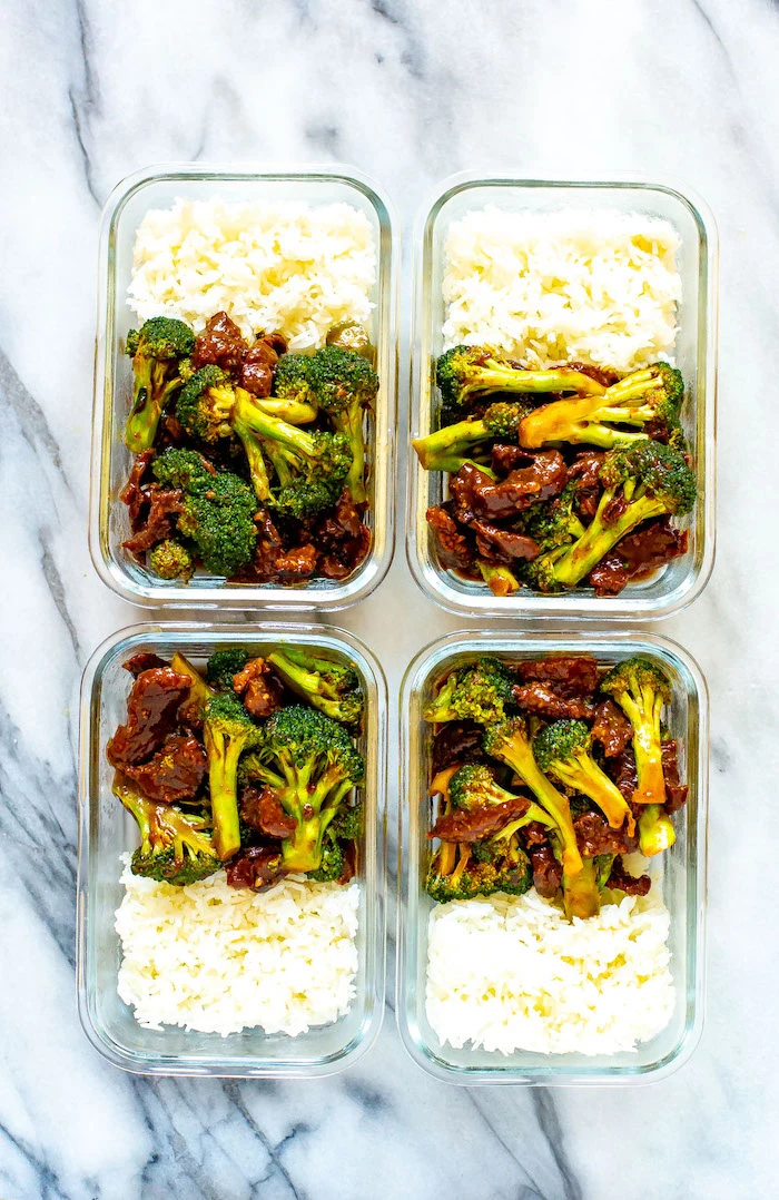 four glass boxes filled with beef and broccoli and white rice placed on marble surface best instapot recipes meal prep