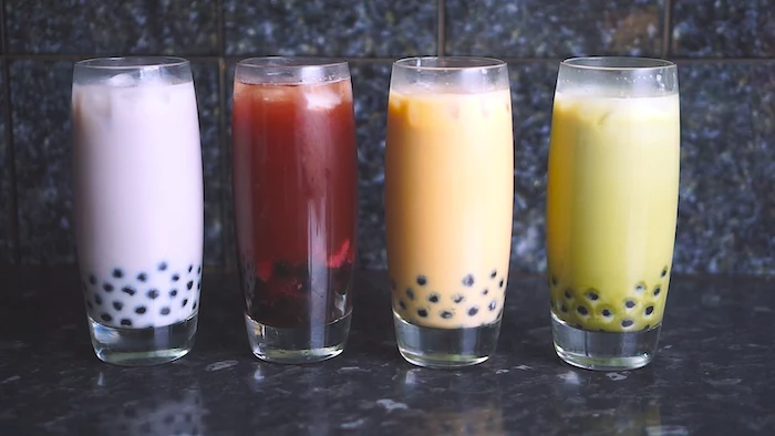 four glasses filled with bubble tea in different colors what is boba made of purple red orange green
