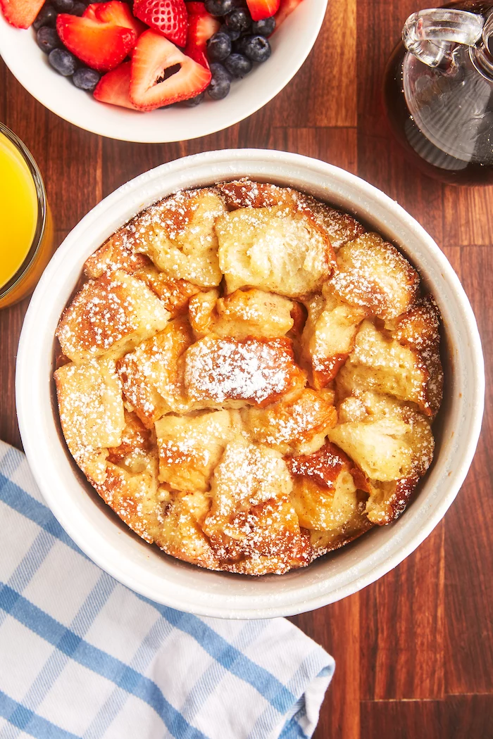 french toast made in an instant pot transferred to ceramic bowl healthy instant pot recipes placed on wooden table with a bowl of berries