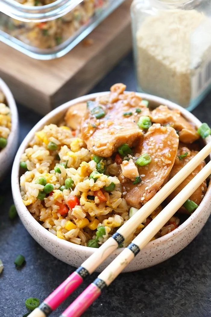 fried rice with chicken quick instant pot recipes garnished with chives and sesame seeds inside ceramic bowl