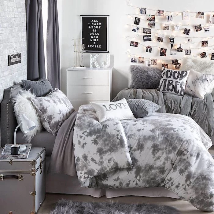 gray bed linen with white and gray throw pillows teen girl room ideas white walls polaroids hanging on the wall with fairy lights