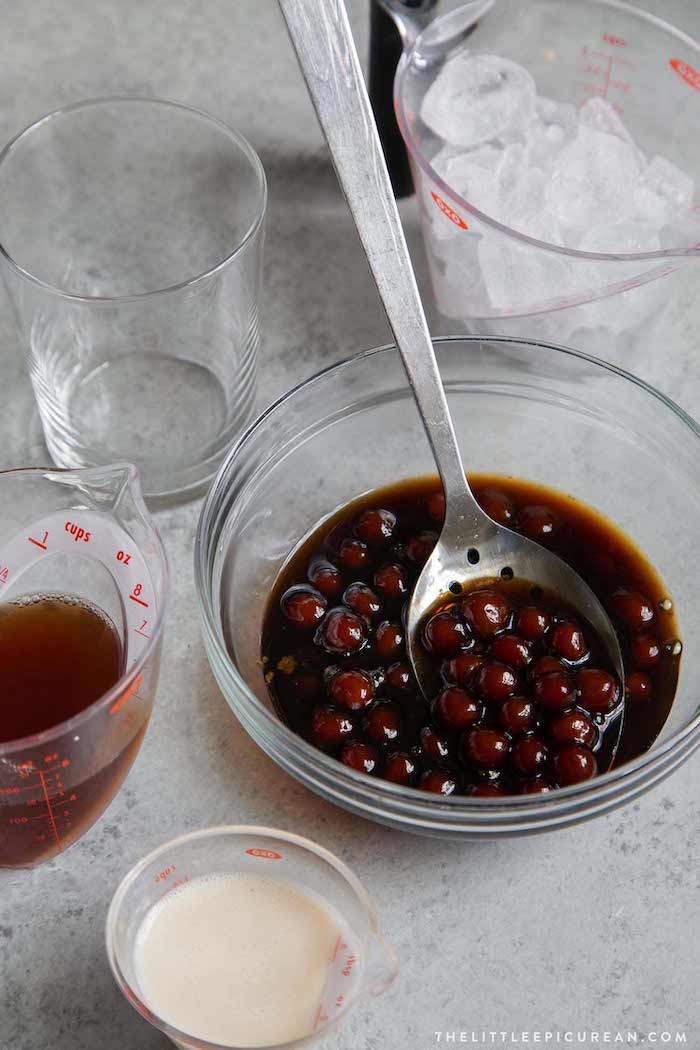 homemade boba brown sugar tapioca pearls how to make tapioca pearls placed inside glass bowl next to ingredients