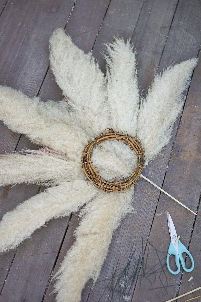 how to dry pampas grass back of the wreath made with white grass placed on wooden surface scissors on the side