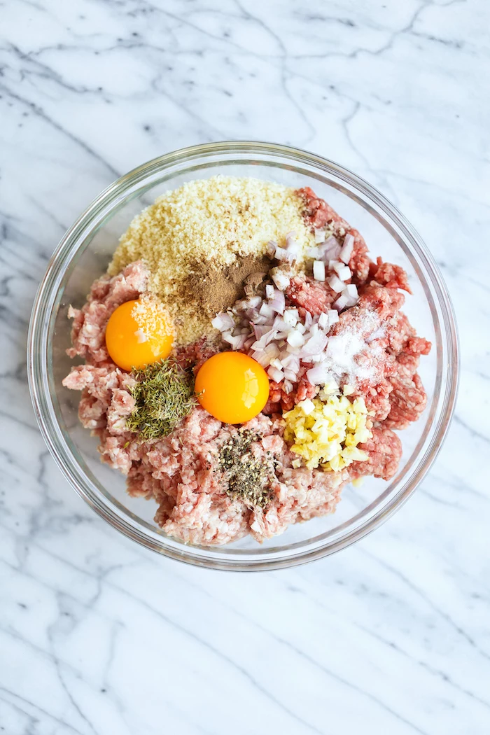 instant pot chicken recipes healthy minced meat herbs onion eggs breadcrumbs inside glass bowl placed on marble surface