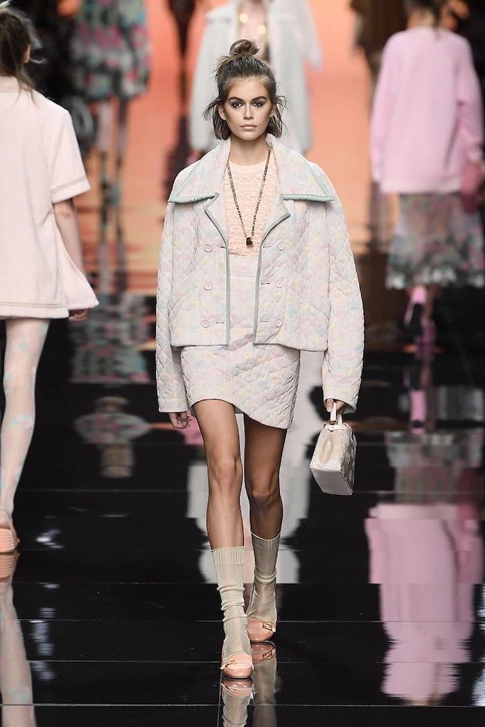 kaia gerber walking on the runway cute outfits for women wearing skirt with oversized jacket carrying small bag