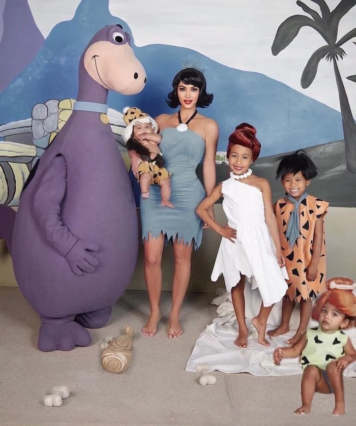 kim kardashian with north saint chicago and psalm dressed as characters from the flintstones family of 4 halloween costumes