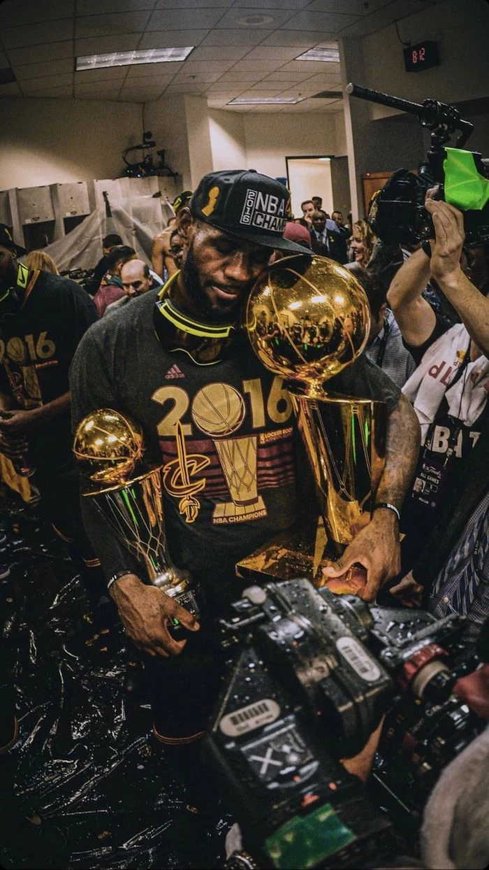 lebron james background in the locker room holding the larry obrient championship trophy finals mvp trophy