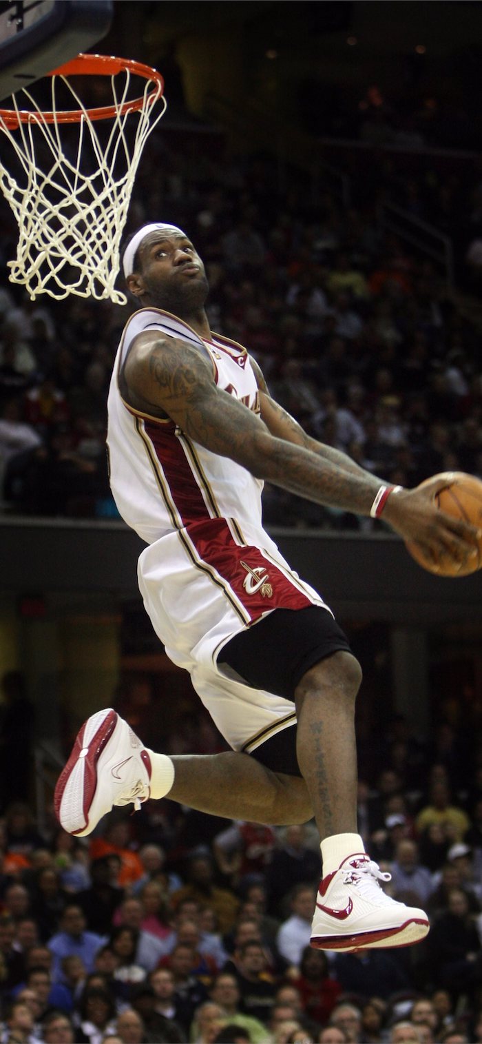 lebron james jumping in the air about to dunk the ball wearing cleveland cavaliers uniform lebron james background