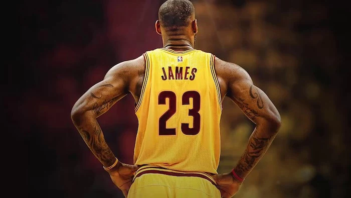 lebron james photographed from the back wearing yellow cleveland cavaliers uniform lebron wallpaper blurred background