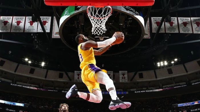 lebron james photographed jumping in the air about to dunk the ball lakers wallpaper wearing lakers uniform