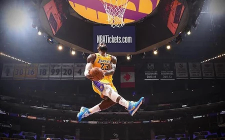 lebron james wallpaper wearing lakers uniform phototgraphed in the air about to dunk the ball