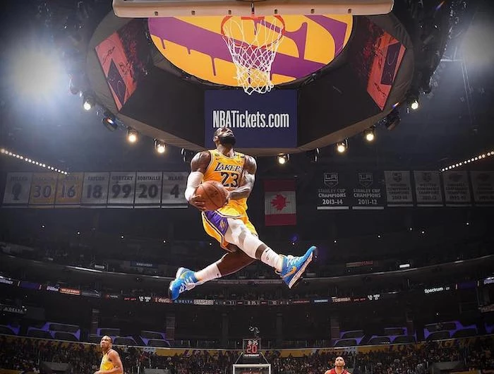 lebron james wallpaper wearing lakers uniform phototgraphed in the air about to dunk the ball