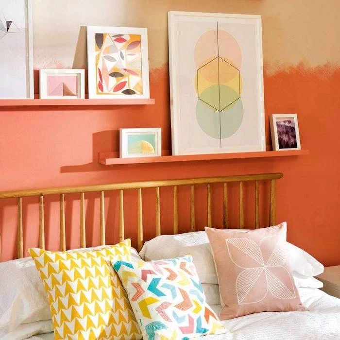orange wall with shelves and framed art on them cozy teenage girl room colorful throw pillows on the bed with wooden frame