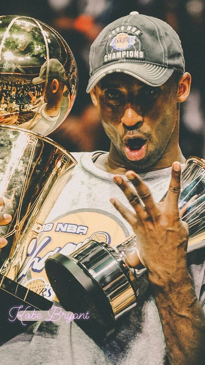 photo of kobe during the finals holding the nba championship trophy and finals mvp trophy lakers wallpaper gray t shirt and champions cap