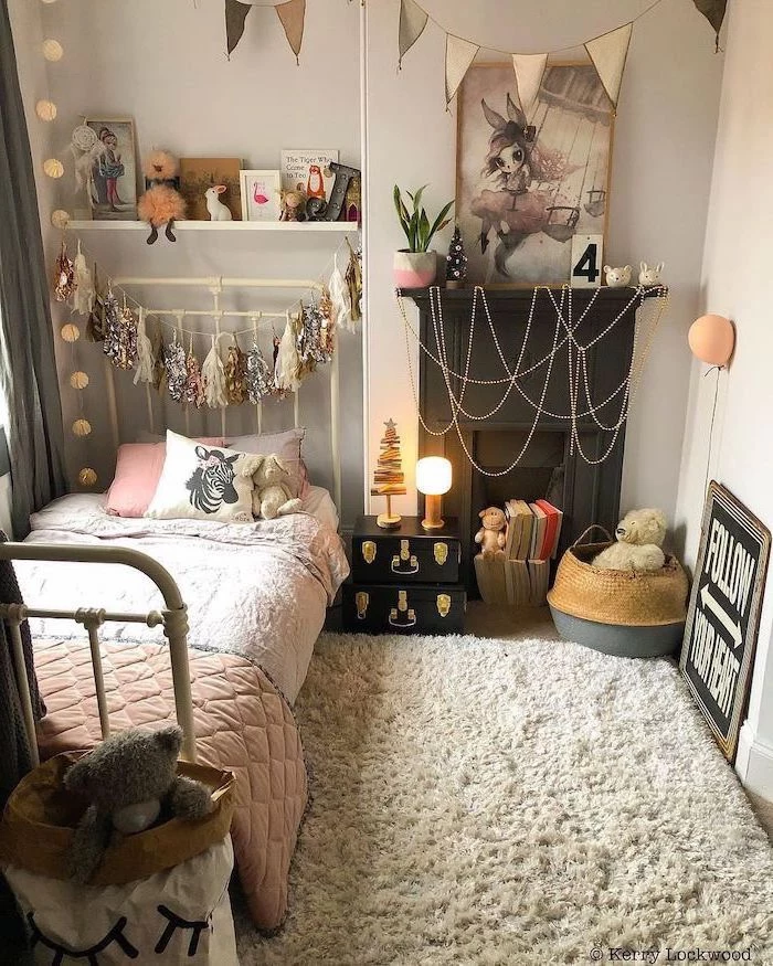 small bed tassel garland hanging above it teen girl room ideas white carpet on wooden floor white walls